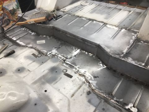 1992 Jeep Wrangler - The interior floor of a vehicle undergoing body work, with freshly welded metal panels visible.