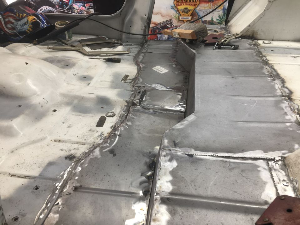 Interior floor pan repair with fresh welds and metal patches