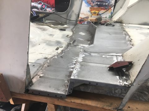 1992 Jeep Wrangler - The floor pan of a vehicle is being repaired with freshly welded metal sections.