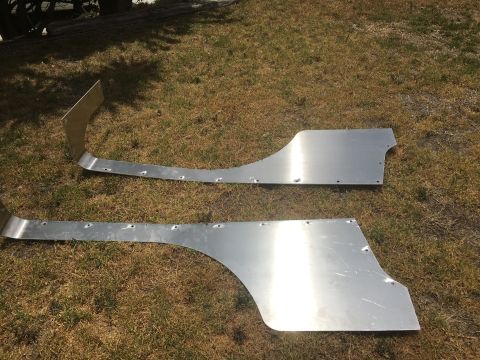 1992 Jeep Wrangler - These aluminum panels are laid out on the grass, showing their shape and pre-drilled holes for installation.