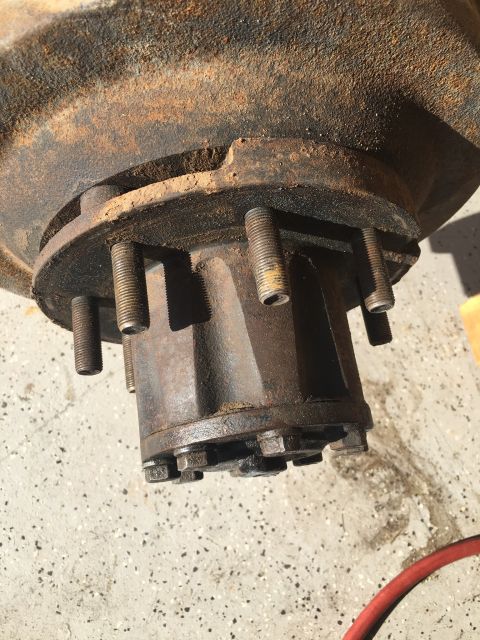 1992 Jeep Wrangler - Close-up of a heavily rusted wheel hub assembly, showing the lug studs and central mounting hardware.