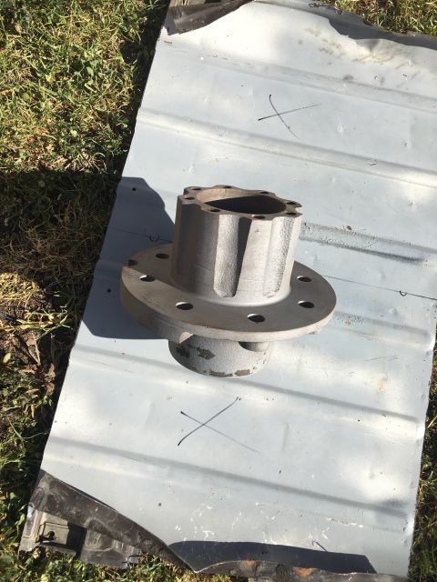 1992 Jeep Wrangler - A metal hub assembly is shown on a metal surface, with grass in the background.
