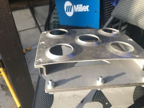 1992 Jeep Wrangler - A metal bracket with multiple circular openings is shown, with a Miller welding machine visible in the background.
