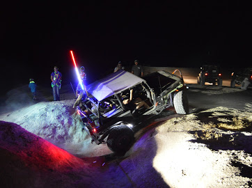 1992 Jeep Wrangler - This off-road vehicle is navigating a dirt path at night, illuminated by various lights.