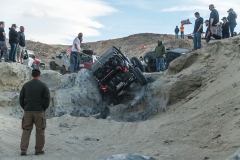 1992 Jeep Wrangler - Spectators watch as an off-road vehicle navigates a challenging rocky terrain.