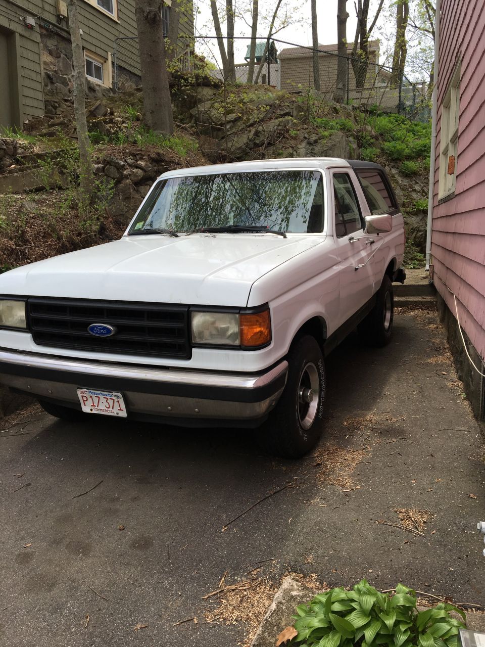 White Ford Bronco parked on asphalt, front 3/4 view, showing a license plate reading P17 371