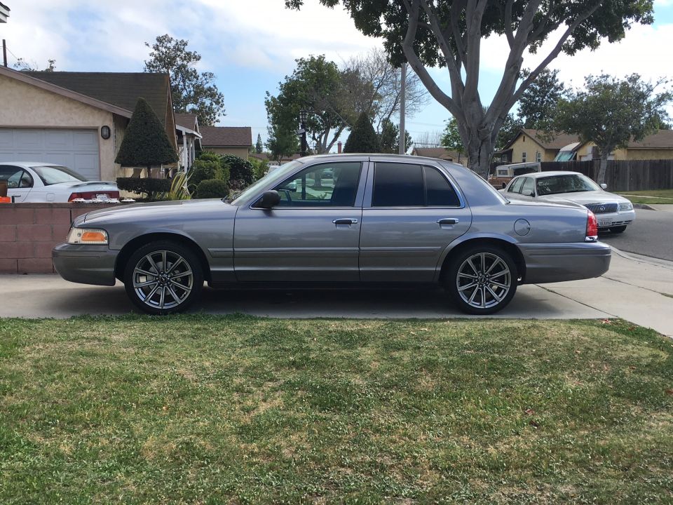 Silver sedan parked on a residential street, side view