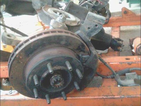 1978 Ford Bronco - Close-up view of a brake rotor and caliper assembly, likely from a vehicle undergoing maintenance or repair.