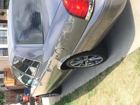1989 Mazda MX-6 - The rear quarter panel and wheel of a gray sedan are visible in this side view.