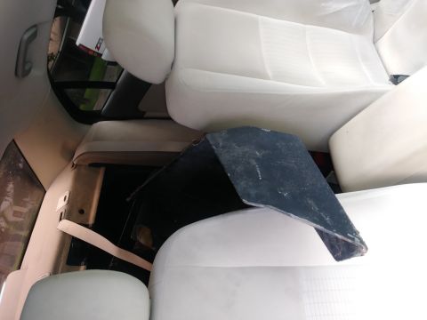 1996 Ford Bronco - Interior of a vehicle with white seats and a black panel covering the floor area.
