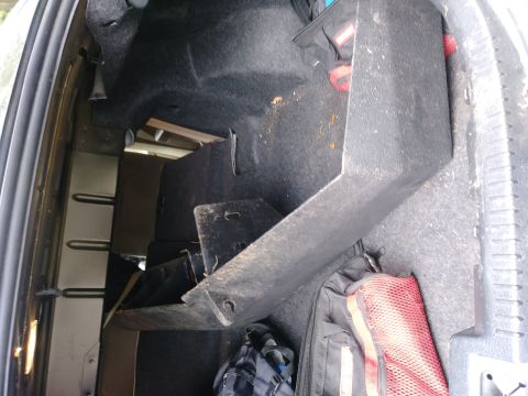 1996 Ford Bronco - The cargo area of a vehicle contains various items, including storage compartments and bags.