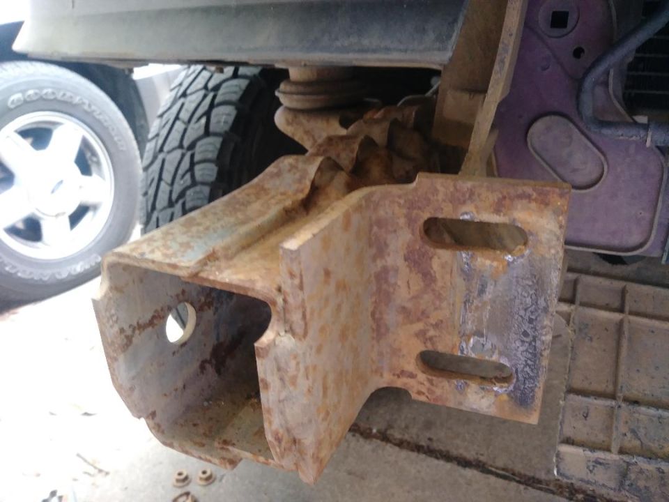 Rusted bumper bracket with visible mounting holes