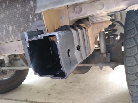 1996 Ford Bronco - Close-up view of a vehicle's frame and suspension system, showing a black metal bracket.