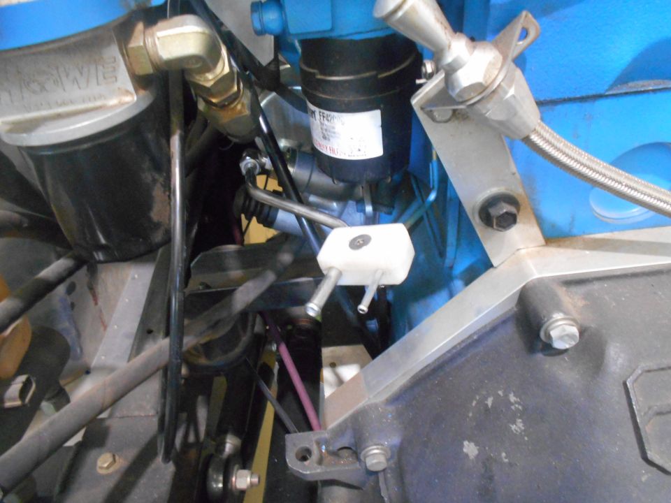 Close-up of engine bay with fuel filter and various hoses and fittings