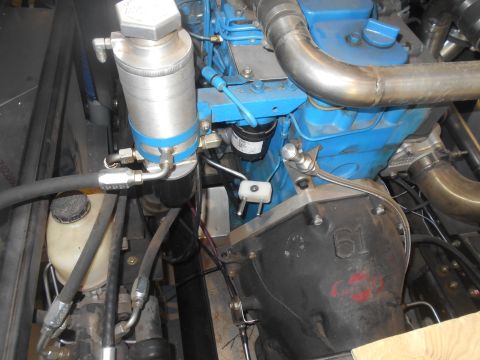 1992 Ford Bronco - Close-up view of an engine compartment, showing various mechanical components and plumbing.