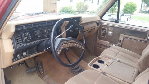 1985 Ford Bronco - Interior view of an older pickup truck, likely from the 1980s, with a prominent dashboard and seating.