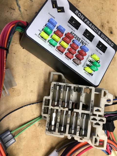 1971 Dodge Charger - Automotive fuse box and wiring harness components are laid out on a wooden surface.