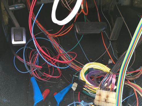 1971 Dodge Charger - A complex web of wires and connectors fills the interior of a vehicle, obscuring any specific model year details.