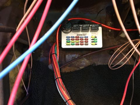 1971 Dodge Charger - Close-up of an aftermarket fuse box and wiring harness, likely installed in a vehicle's interior.
