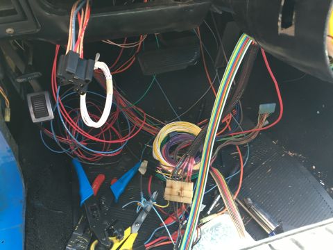 1971 Dodge Charger - Vehicle wiring harness with many colorful wires and connectors, tools for electrical work are visible.