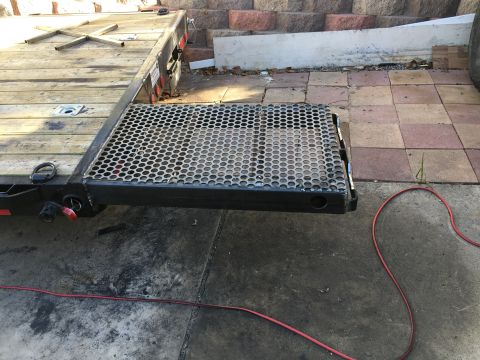 1992 Jeep Wrangler - A flatbed trailer is shown from the rear, with a wooden deck and a metal ramp.