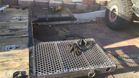 1992 Jeep Wrangler - A trailer ramp is shown with tools and gloves, next to a large tire, suggesting ongoing work or preparation.