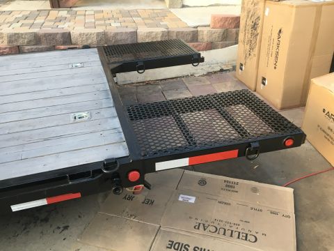 1992 Jeep Wrangler - A flatbed trailer with deployable ramps is shown, with several cardboard boxes in the background.