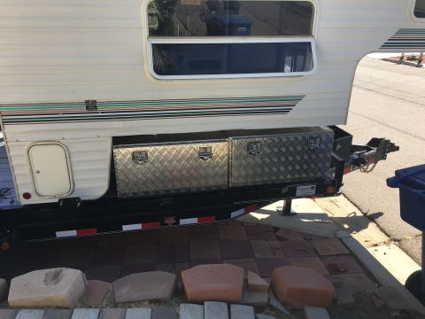 1992 Jeep Wrangler - Side view of a truck camper with diamond plate toolboxes and a decorative stripe decal.