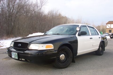 2001 Ford Crown Victoria - This 2001 Ford Crown Victoria police car is seen from the front-right in a three-quarter view, with a two-tone black and white paint scheme.