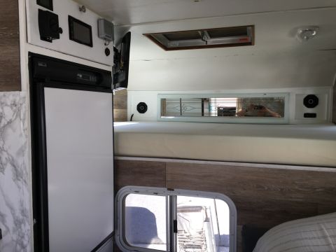 1992 Jeep Wrangler - Interior view of a camper or RV, a refrigerator and sleeping area.