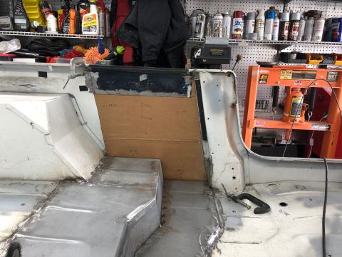1992 Jeep Wrangler - The interior of a Jeep shows metal floor repairs and a cardboard panel with handwritten notes.