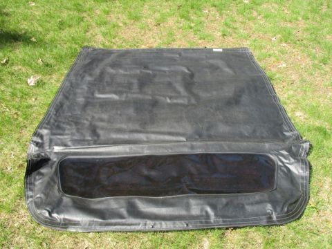 1996 Ford Bronco - Soft top with plastic window, likely for a convertible, photographed outdoors on grass.