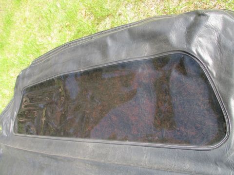 1996 Ford Bronco - A close-up view of a black soft top window, showing the interior fabric and a website watermark.