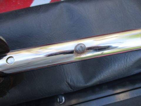 1996 Ford Bronco - Close-up of chrome trim and black upholstery, with visible rivets and rust.