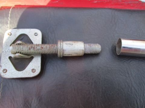 1996 Ford Bronco - Close-up of a soft top latch mechanism, showing the threaded bolt and a detached metal sleeve.