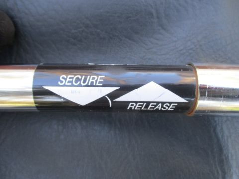 1996 Ford Bronco - Part with instructions for securing and releasing, possibly for a vehicle component.