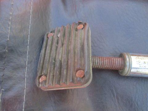 1996 Ford Bronco - Close-up of a used brake pedal pad, showing wear and tear on the rubber surface.
