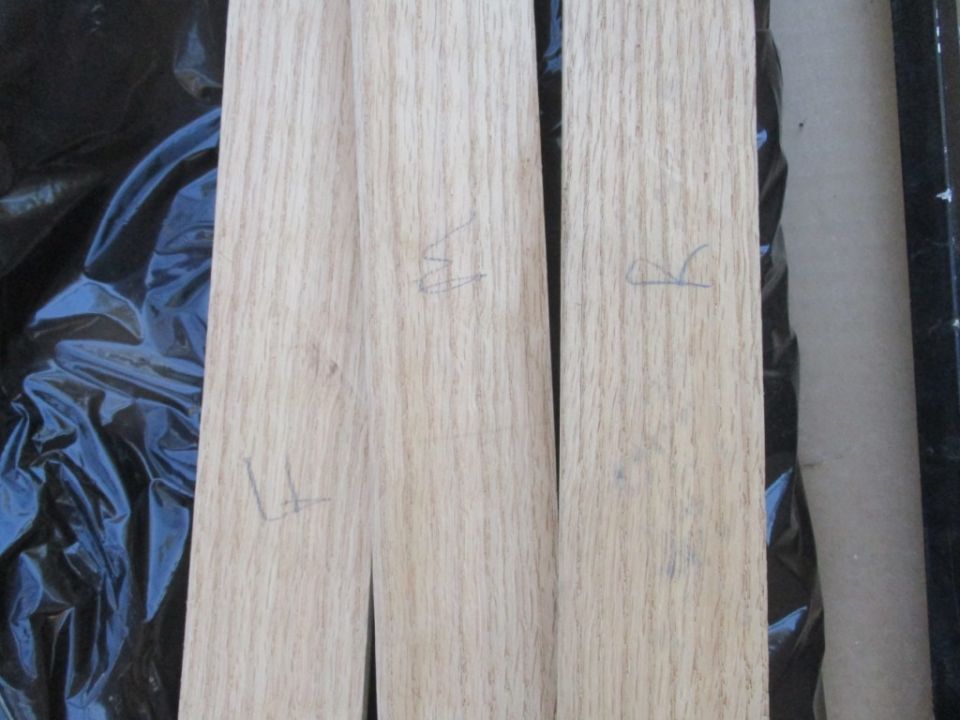 Two unfinished wood trim pieces with pencil markings 'L', 'R', and 'S'