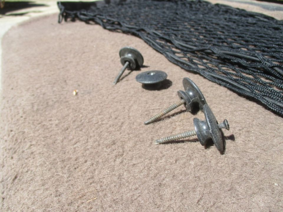 Cargo net and mounting hardware on carpeted surface