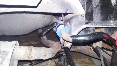 2000 Pontiac Grand Prix - Close-up of a rear suspension sway bar with blue polyurethane bushings.