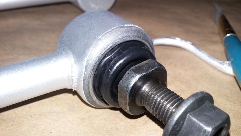 2000 Pontiac Grand Prix - A close-up view of a vehicle suspension component, possibly a sway bar end link, with visible text from Supermotors.net.