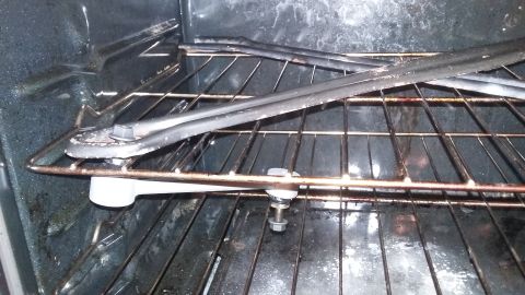 2000 Pontiac Grand Prix - A windshield wiper assembly is placed inside a dirty oven on its racks.