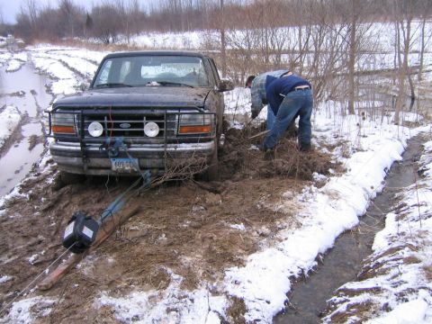1994 Ford Bronco - winch hooked to tow strap hooked to brush guard to frame