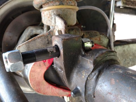 1992 Ford Bronco - Close-up view of a track bar stud repair, showing a large nut and bolt assembly.