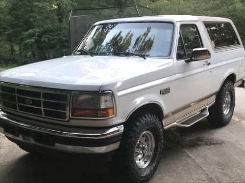 1996 Ford Bronco - White 1996 Ford Bronco with tan two-tone trim and running boards.