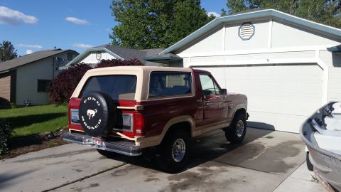 1985 Ford Bronco - This Ford Bronco is parked in front of a suburban garage on a sunny day.
