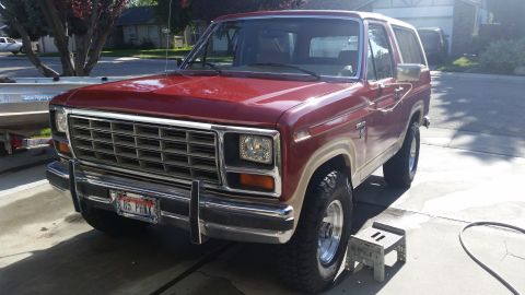1985 Ford Bronco - This 1985 Ford Bronco is shown in a front 3/4 view, a prominent grille and a license plate indicating the year.