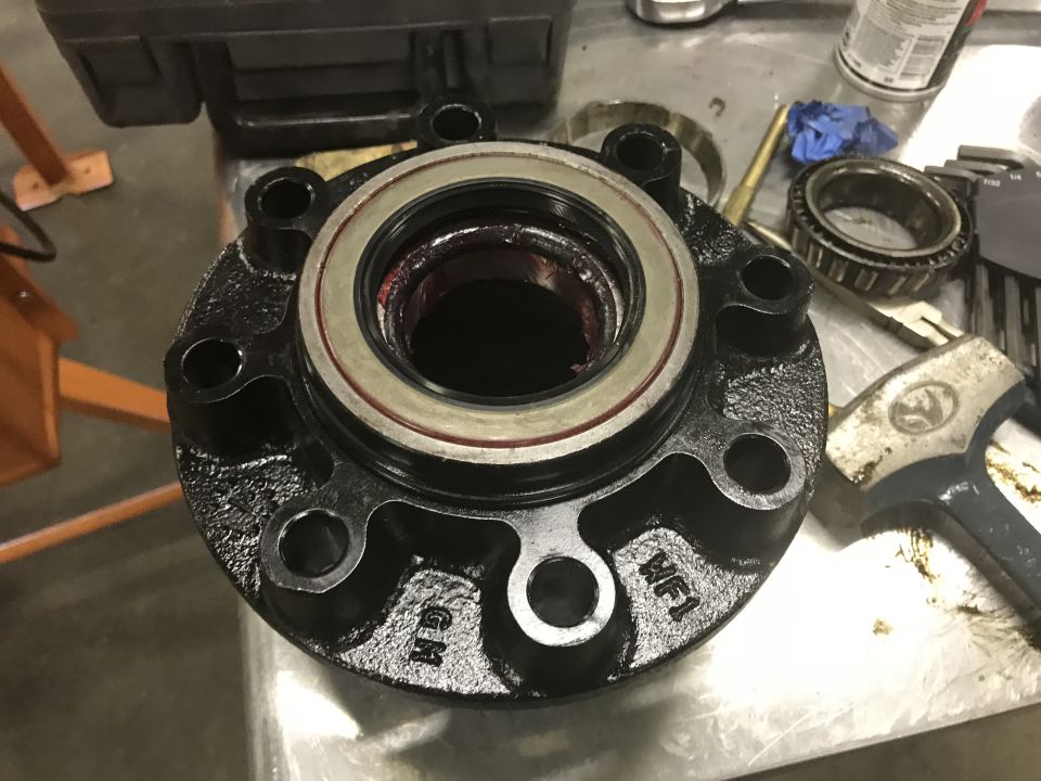 Black wheel hub with bearing and "GM" marking