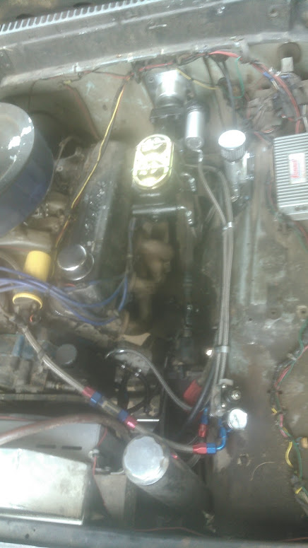 1978 Ford Bronco - Close-up view of an engine bay, showing plumbing and electrical connections.