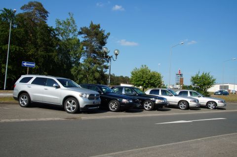 2003 Mercury Marauder - Several cars are parked in a lot on a sunny day.